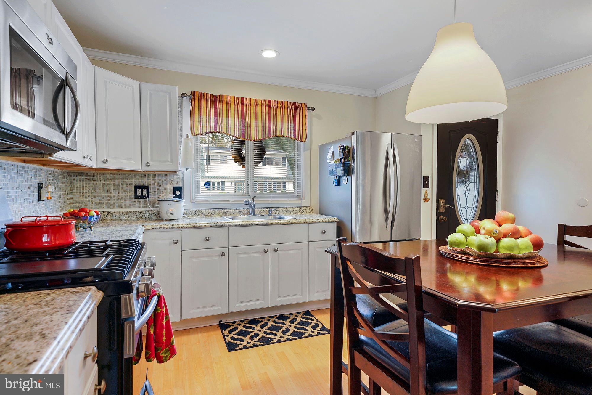 3 Albemarle Road Hamilton, NJ 08690 - Photo 5 of 27 a kitchen with stainless steel appliances kitchen island granite countertop a table chairs in it and a window