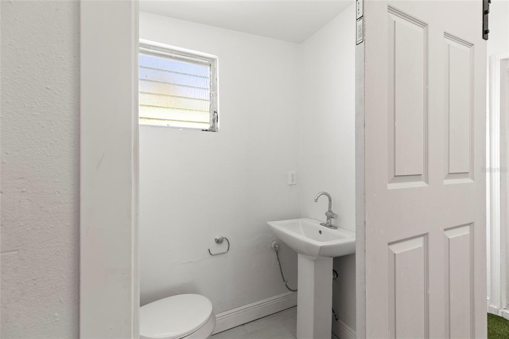 250 Rosery Road Northwest, Unit 314 Largo, FL 33770 - Photo 15 of 16 a bathroom with a sink a toilet and shower