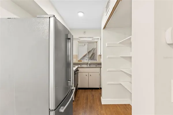 a kitchen with granite countertop a sink and a stove