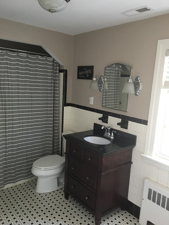 4 Latin Road Boston, MA 02132 - Photo 12 of 16 a bathroom with a sink a toilet and a mirror