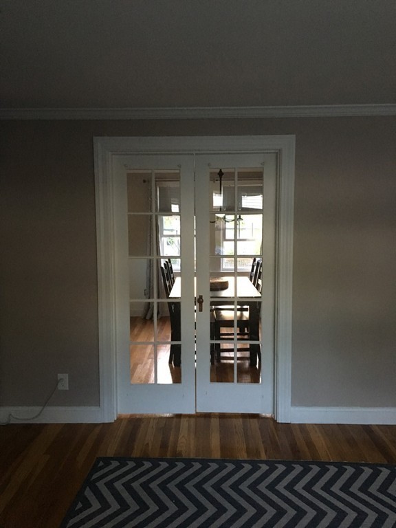 4 Latin Road Boston, MA 02132 - Photo 5 of 16 a view of a livingroom with wooden floor and kitchen