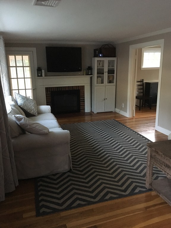 4 Latin Road Boston, MA 02132 - Photo 7 of 16 a living room with furniture a flat screen tv and a fireplace