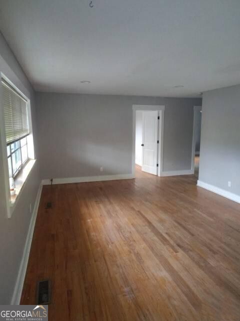 46 Mohawk Trail Ringgold, GA 30736 - Photo 3 of 16 an empty room with wooden floor and windows