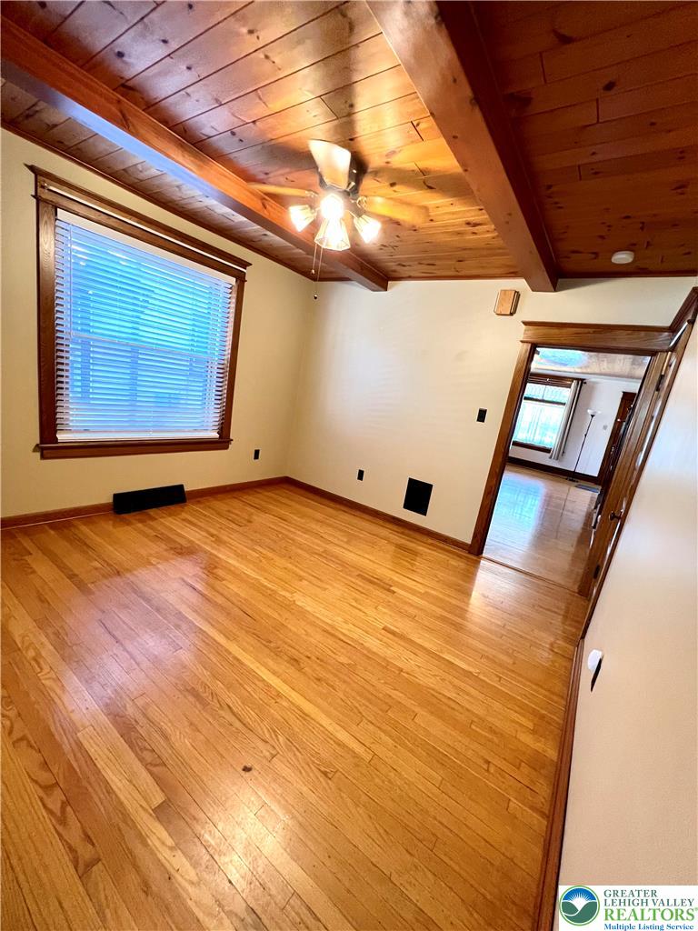 1119 Maple Street Bethlehem, PA 18018 - Photo 2 of 10 Hardwood flooring and beamed ceilings elevate this versatile living area.