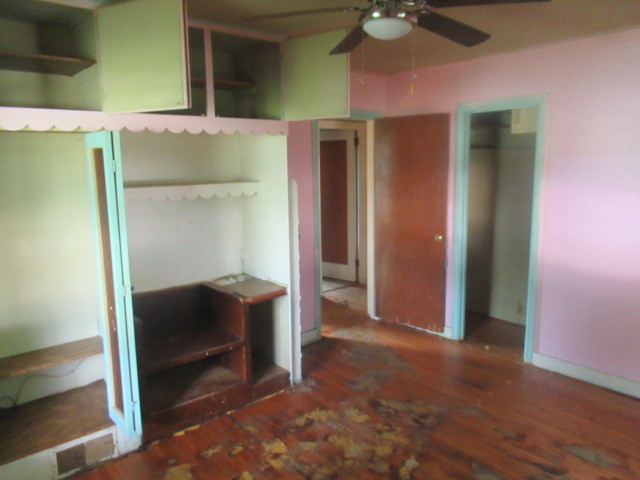 211 South Lafayette Street Byron, IL 61010 - Photo 12 of 26 a view of a room with wooden floor and ceiling fan