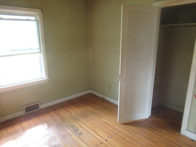 211 South Lafayette Street Byron, IL 61010 - Photo 14 of 26 a view of a room with wooden floor and a window