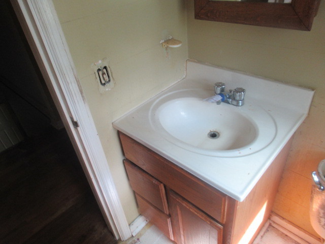 211 South Lafayette Street Byron, IL 61010 - Photo 17 of 26 a bathroom with a sink and a mirror