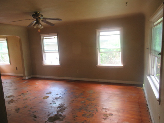 211 South Lafayette Street Byron, IL 61010 - Photo 4 of 26 a view of an empty room window and wooden floor