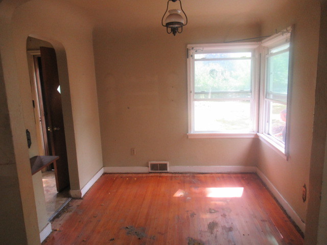 211 South Lafayette Street Byron, IL 61010 - Photo 5 of 26 a view of empty room with wooden floor and fan