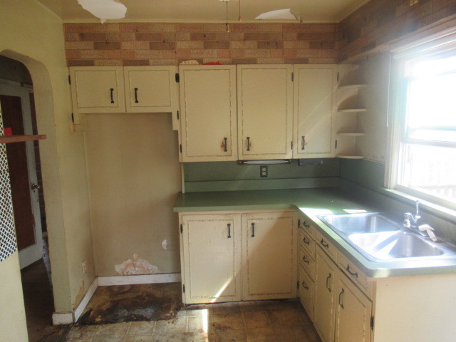 211 South Lafayette Street Byron, IL 61010 - Photo 6 of 26 a kitchen with a sink and a refrigerator