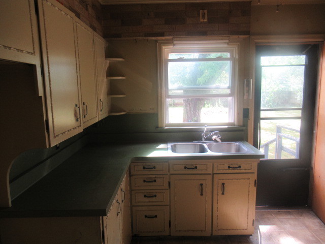 211 South Lafayette Street Byron, IL 61010 - Photo 8 of 26 a kitchen with a sink a window and cabinets