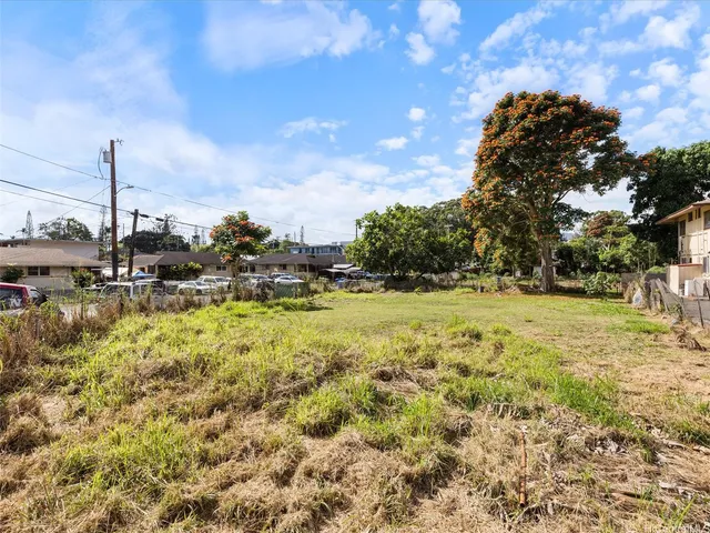 a view of a big yard with table and chairs