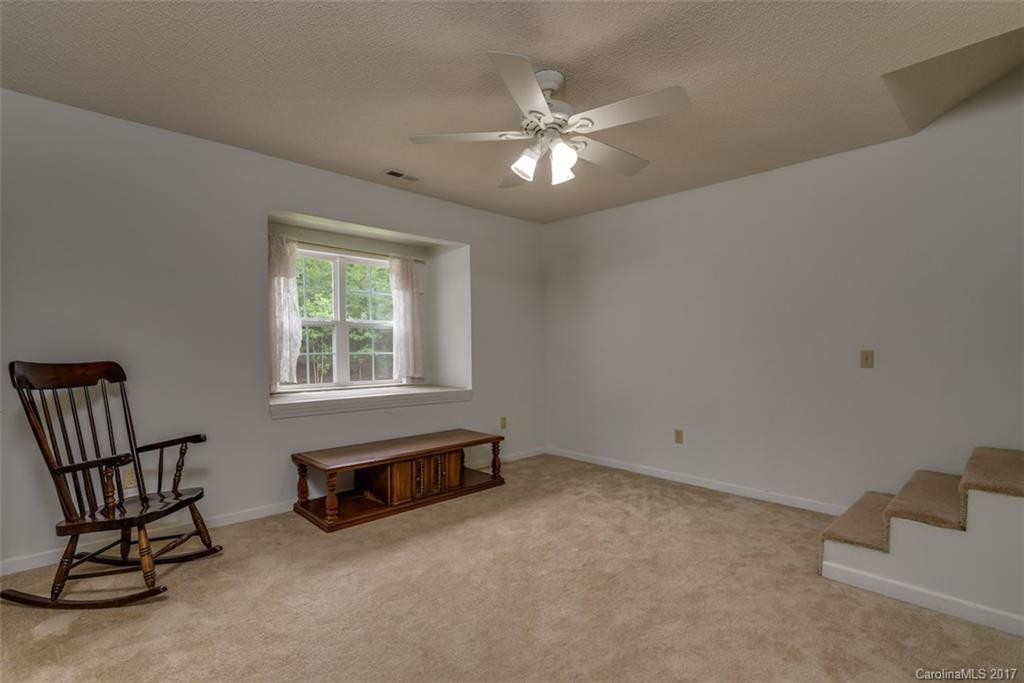 220 Collins Road Forest City, NC 28043 - Photo 14 of 24 a living room with furniture and a chandelier