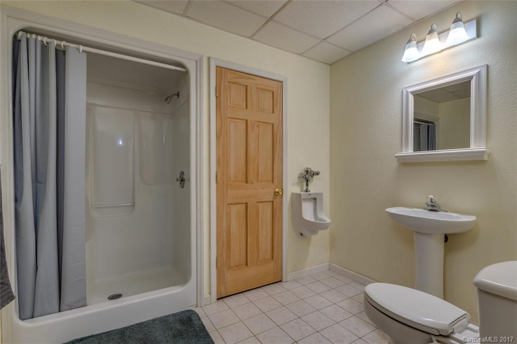 220 Collins Road Forest City, NC 28043 - Photo 22 of 24 a bathroom with a sink a toilet and shower