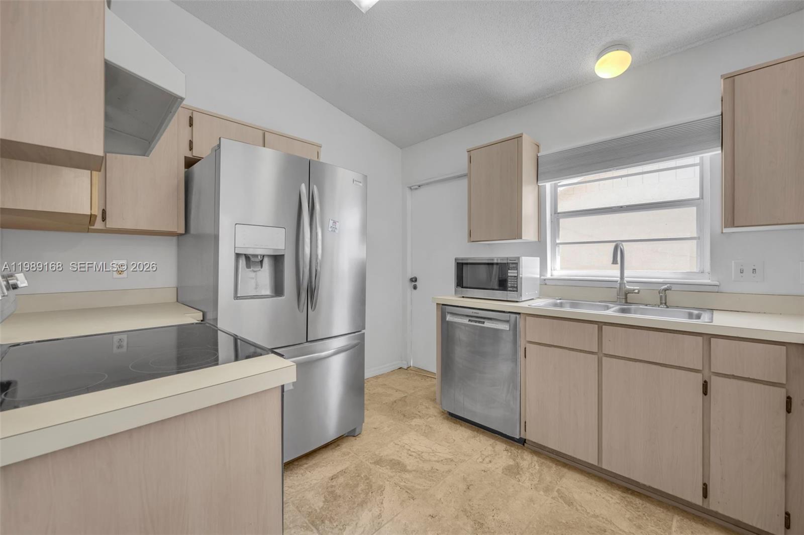 331 San Gabriel Street Winter Springs, FL 32708 - Photo 11 of 26 a kitchen with granite countertop a refrigerator and a sink