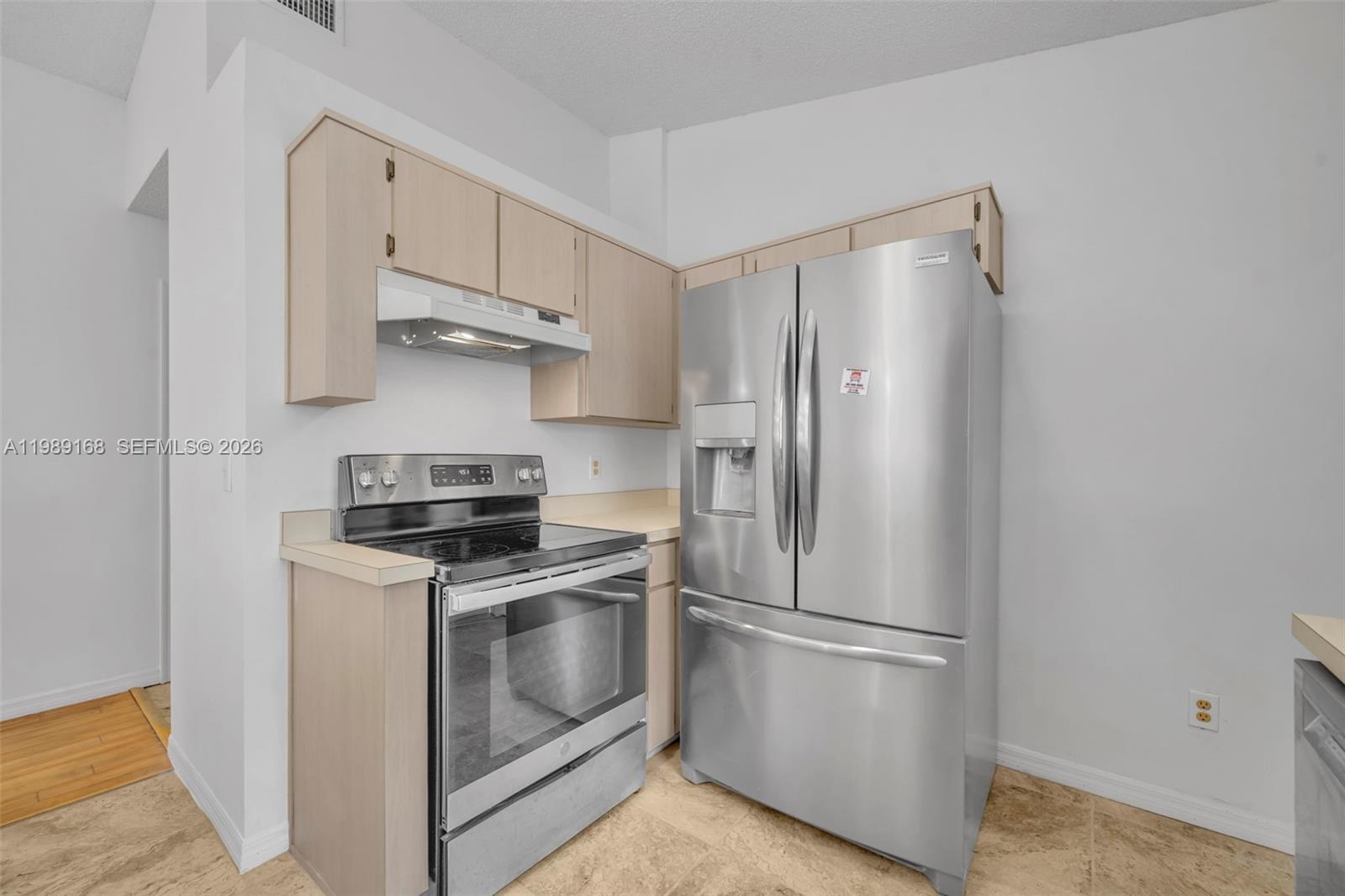 331 San Gabriel Street Winter Springs, FL 32708 - Photo 13 of 26 a kitchen with stainless steel appliances a refrigerator a stove and white cabinets