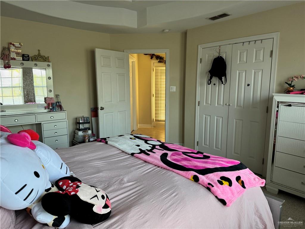 2600 Rhett Drive Pharr, TX 78577 - Photo 18 of 21 a bedroom with a bed and a chandelier