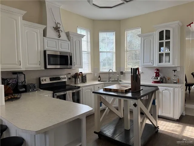 a kitchen with sink cabinets and microwave