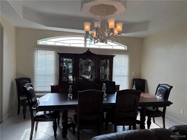 a view of a dining room with furniture and chandelier