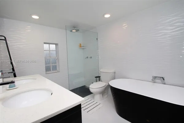 a bathroom with a sink and mirror with toilet