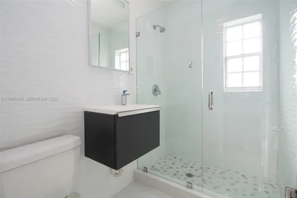 a bathroom with a sink vanity and a mirror
