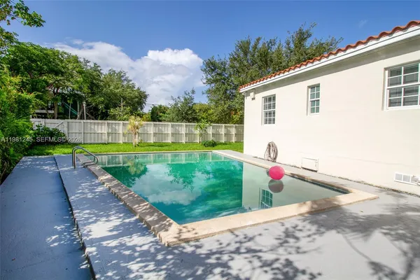 a view of a house with a yard and sitting area