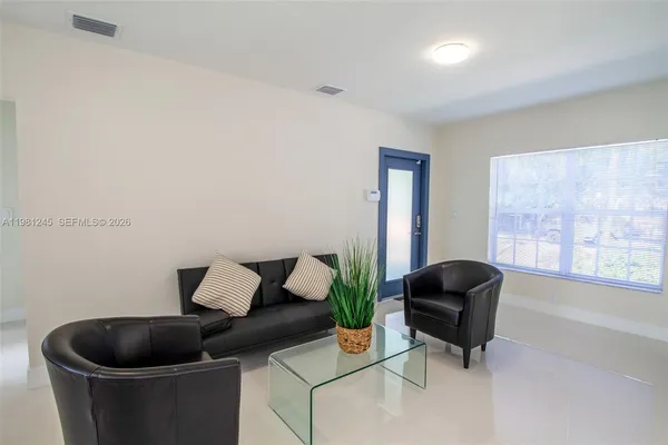 a living room with furniture and a chair