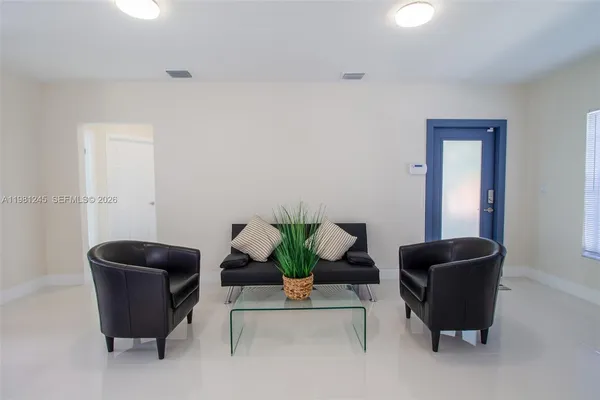 a living room with furniture and a potted plant