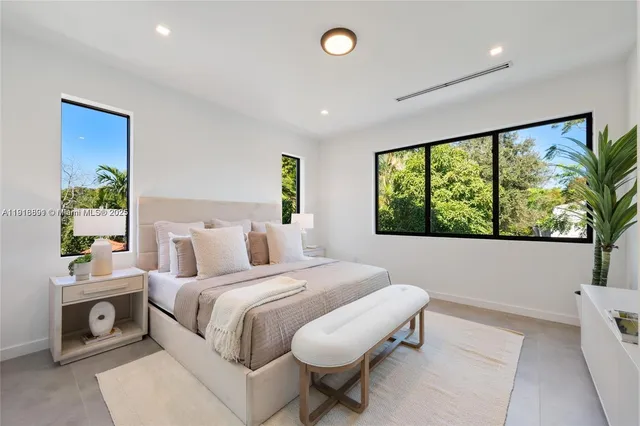 a bedroom with a bed and a large window