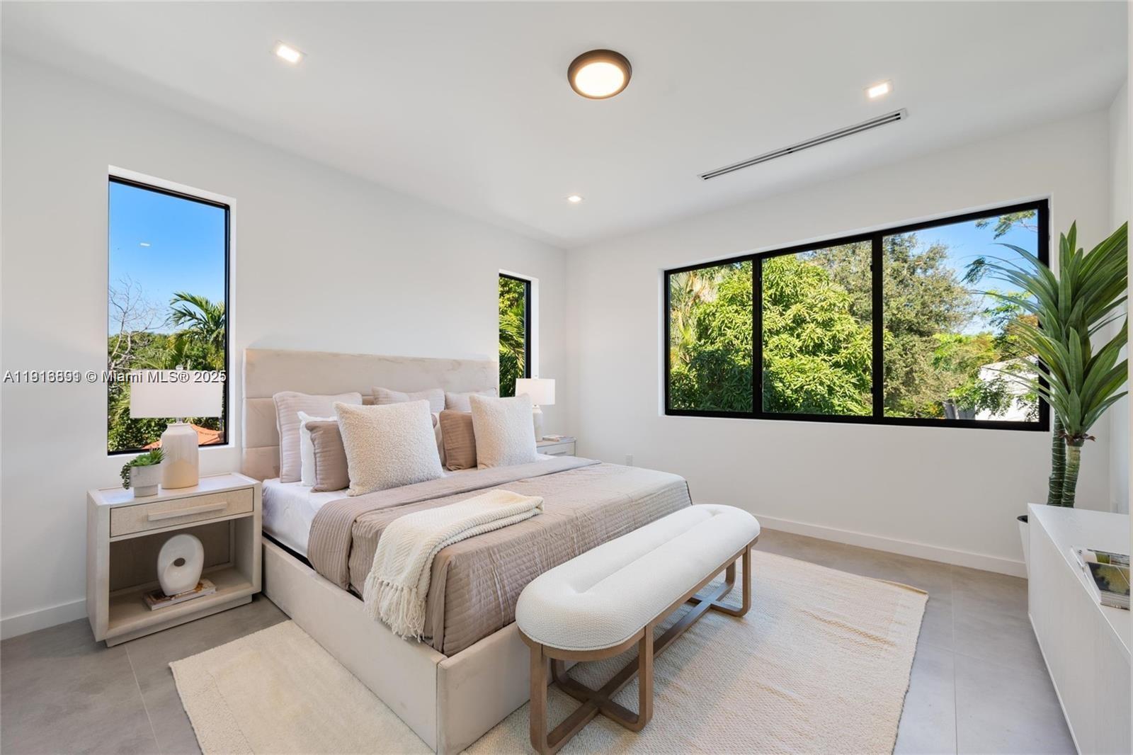 1533 Southwest 22nd Terrace Miami, FL 33145 - Photo 12 of 24 a bedroom with a bed and a large window