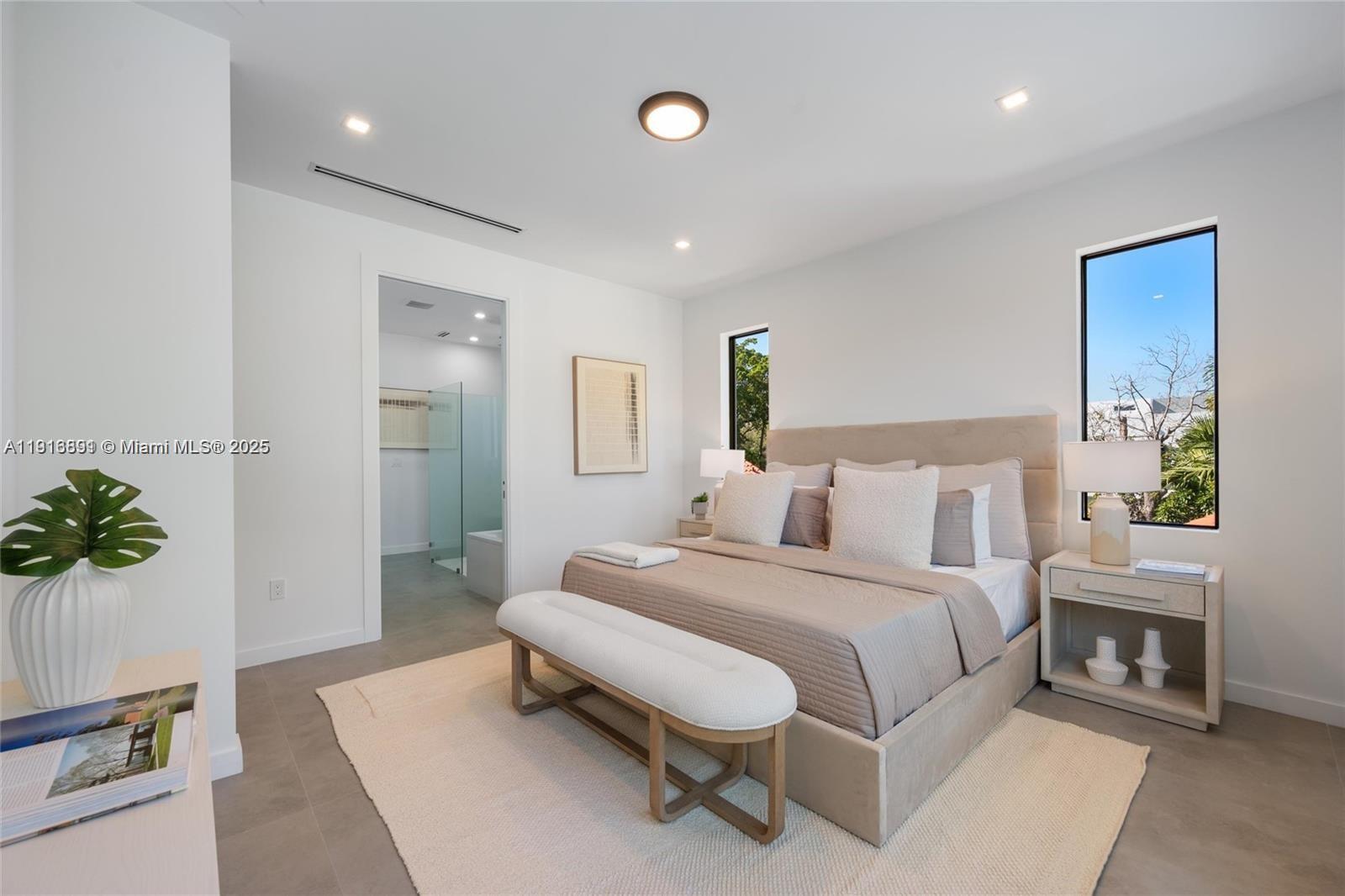 1533 Southwest 22nd Terrace Miami, FL 33145 - Photo 13 of 24 a spacious bedroom with a bed and potted plant