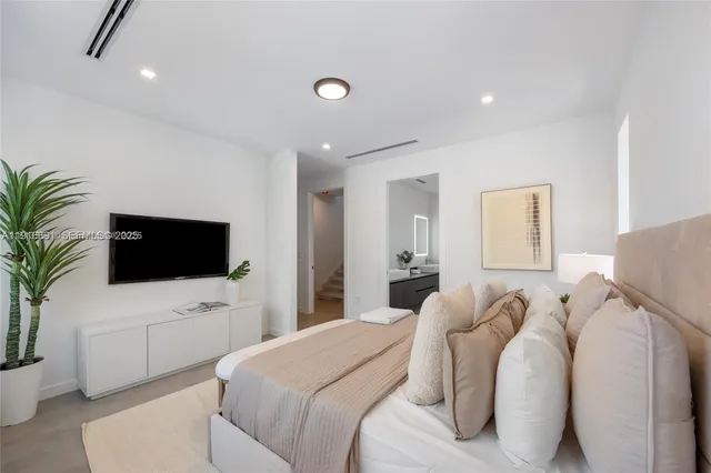 a bedroom with a bed and a flat screen tv