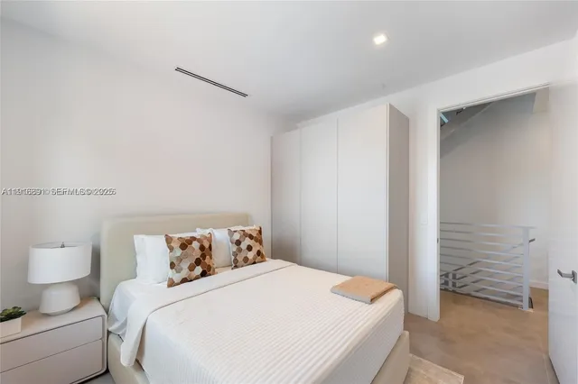 a bedroom with a bed and a night stand