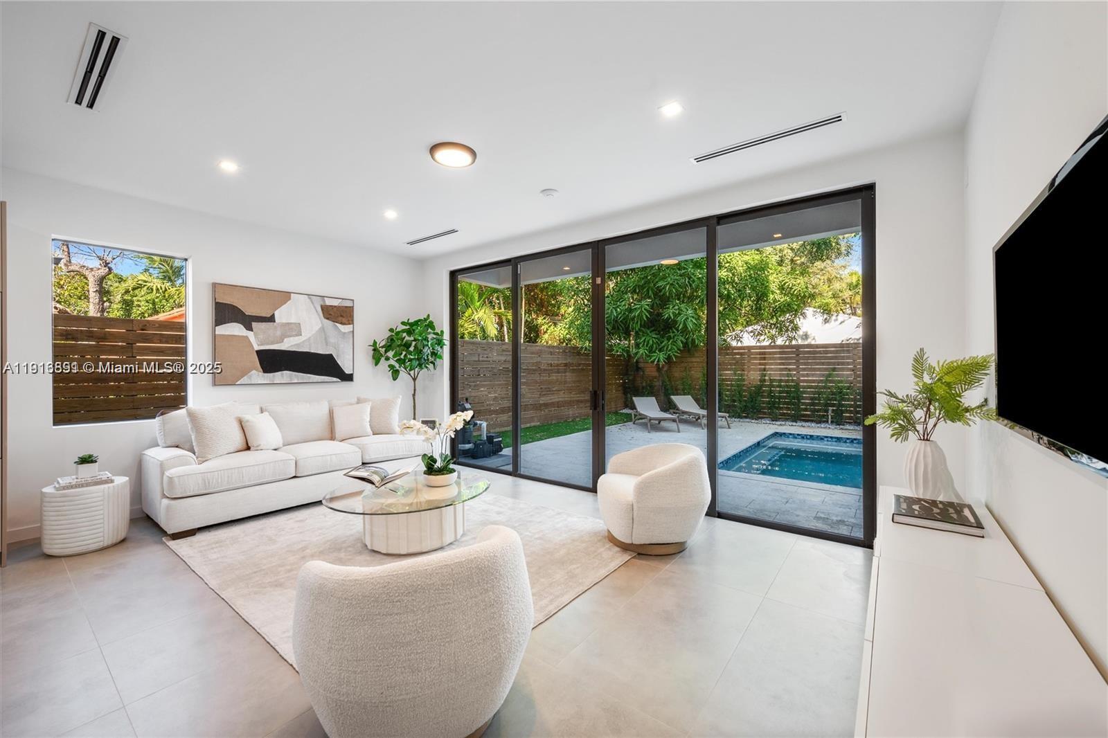 1533 Southwest 22nd Terrace Miami, FL 33145 - Photo 2 of 24 a living room with fireplace furniture and a flat screen tv