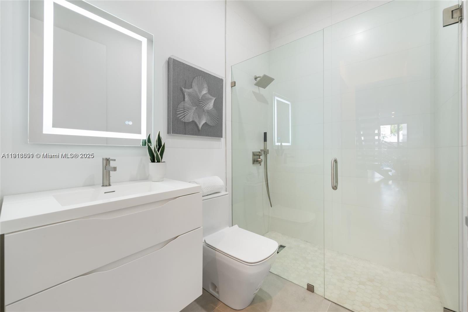 1533 Southwest 22nd Terrace Miami, FL 33145 - Photo 22 of 24 a bathroom with a toilet sink vanity shower and mirror