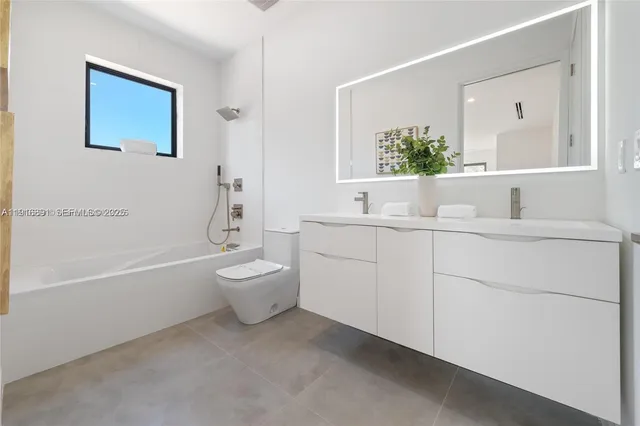 a bathroom with a toilet a sink and a bathtub