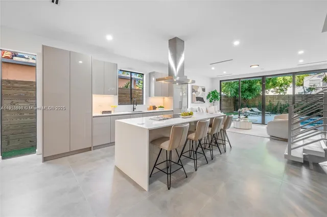 a large kitchen with a table and chairs