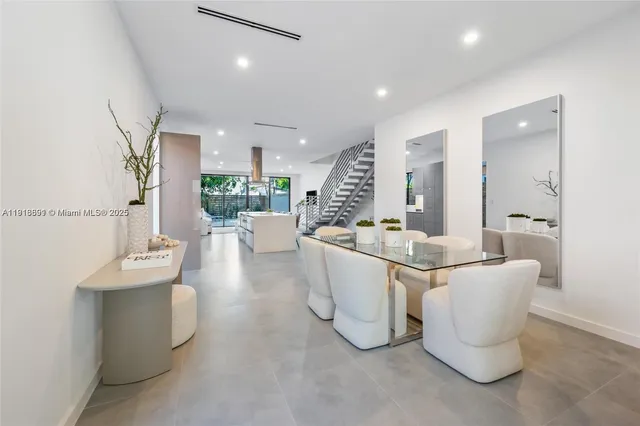 a living room with furniture and a large mirror