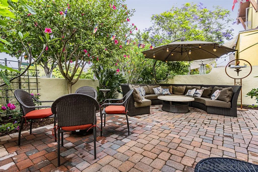 930 10th Street Coronado, CA 92118 - Photo 15 of 25 a backyard of a house with table and chairs