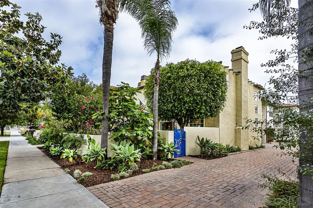 930 10th Street Coronado, CA 92118 - Photo 21 of 25 a front view of a house with a yard and fountain in middle