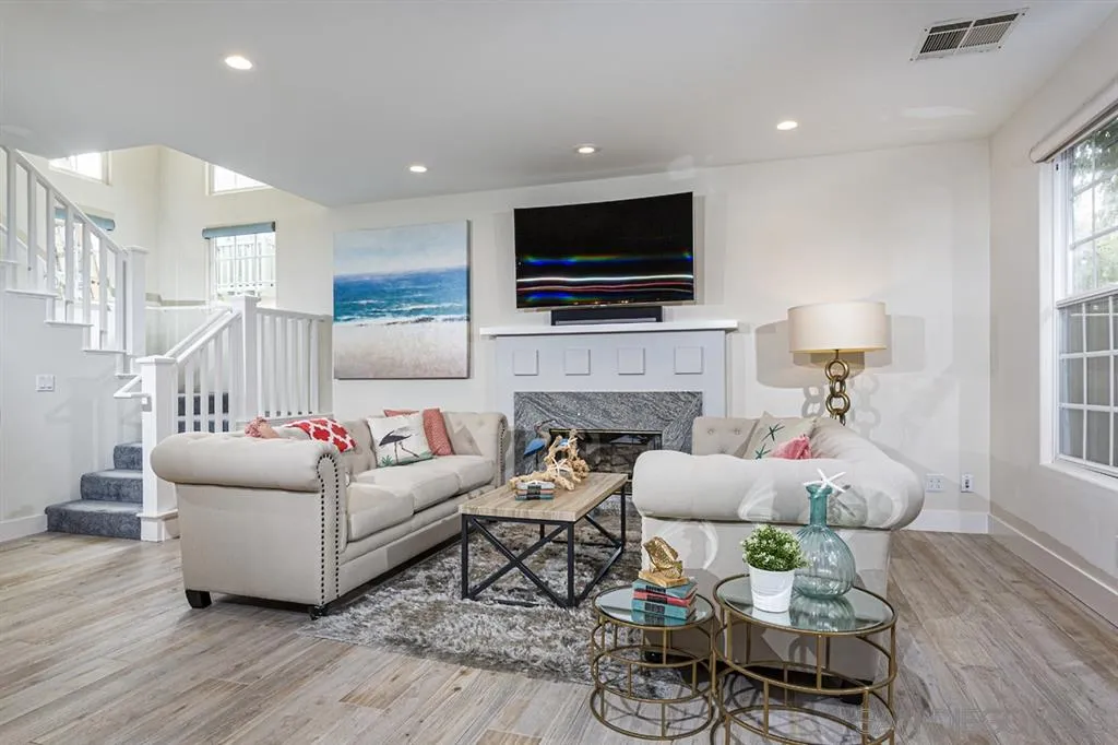 930 10th Street Coronado, CA 92118 - Photo 7 of 25 a living room with furniture a flat screen tv and a fireplace