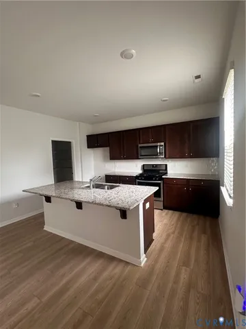 a kitchen with stainless steel appliances a sink and a stove