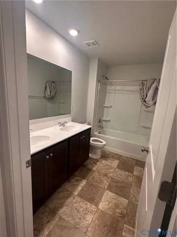 a bathroom with a double vanity sink mirror and shower