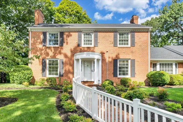 a front view of house with yard and green space