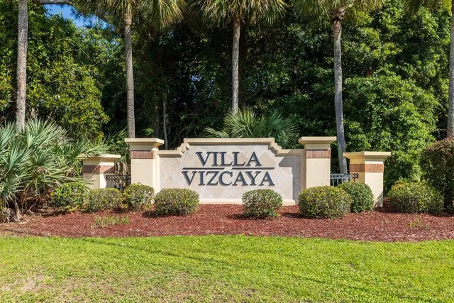 a view of a street with a bench and trees around