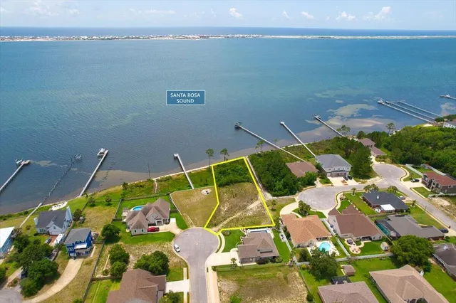 a view of sign board with yard and trees