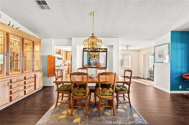 a kitchen with stainless steel appliances granite countertop a sink a stove cabinets counter space and wooden floor