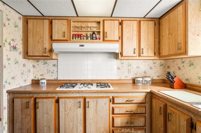 a living room with a large window and chandelier