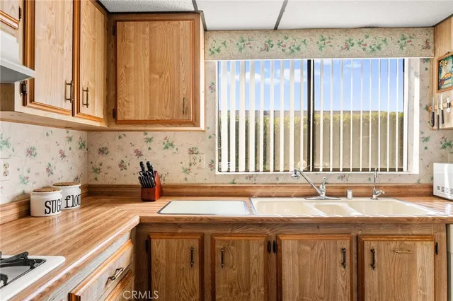 a view of a livingroom with wooden floor and a ceiling fan