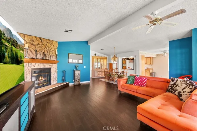 a living room with fireplace furniture and a flat screen tv